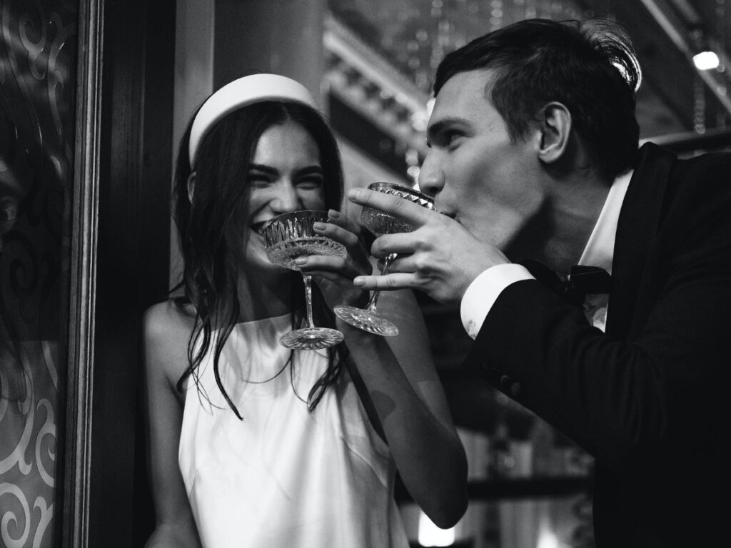 Bride and groom drinking champagne