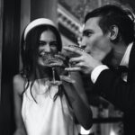 Bride and groom drinking champagne