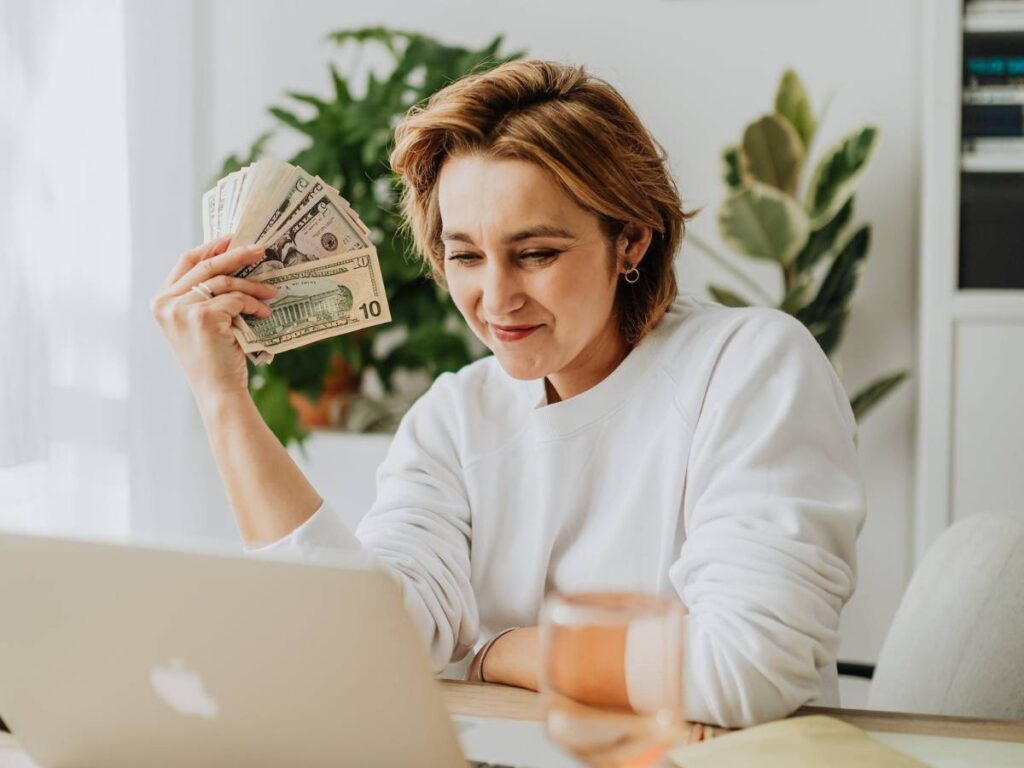 A Woman Holding Dollar Bills