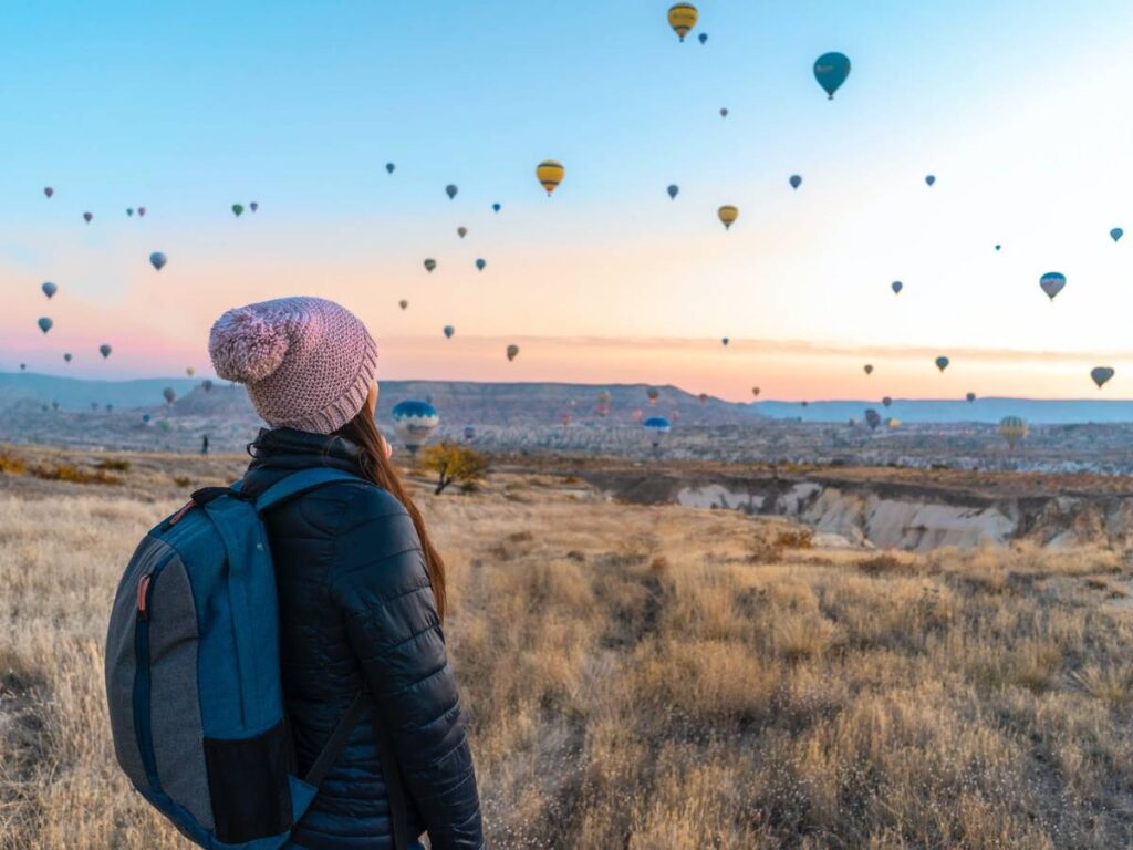 Woman Looking At Hot Air Balloons