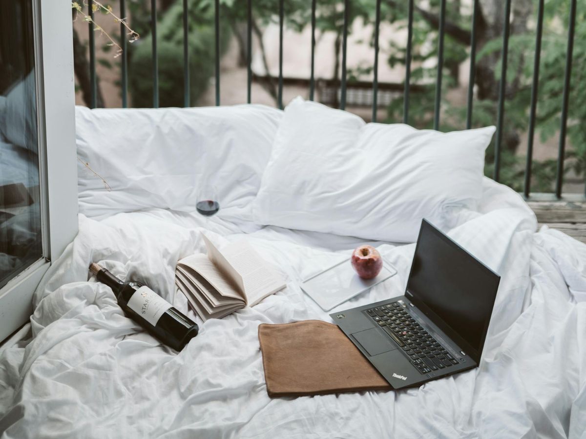 Laptop On Bed Near The Balcony