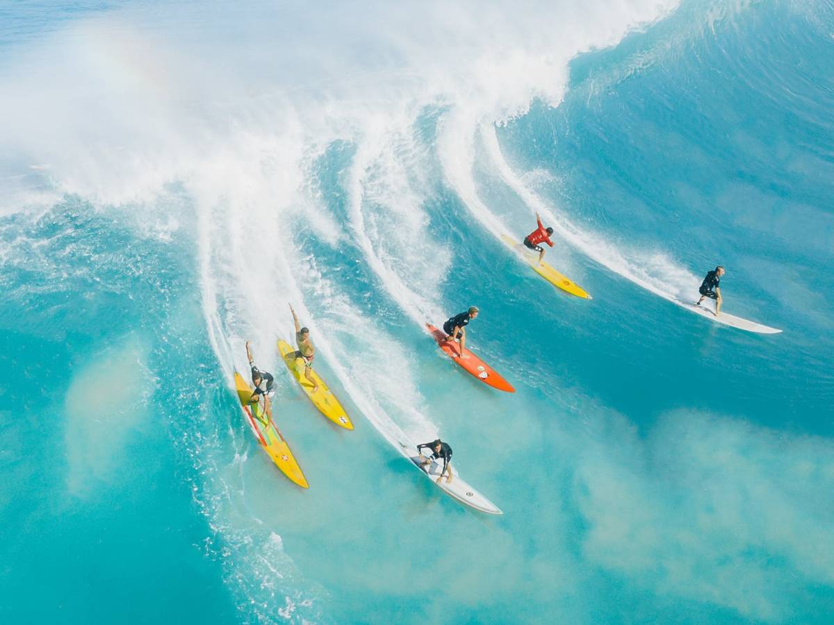 People Surfing on Sea Waves