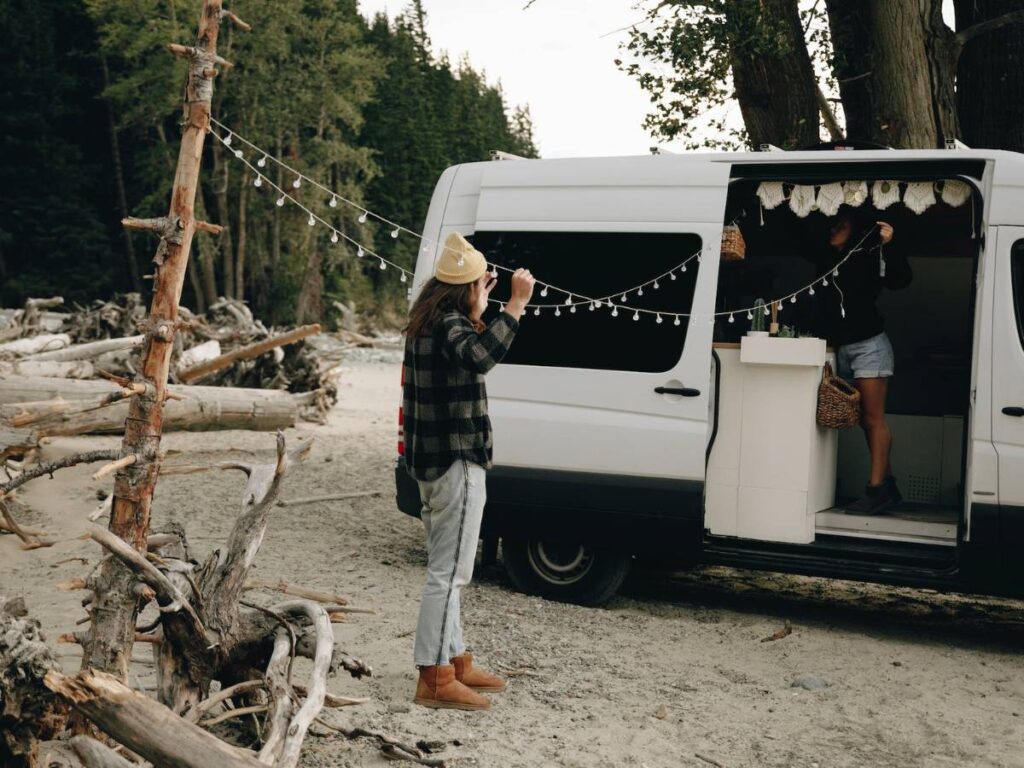 Couple Hanging String Lights Outdoors