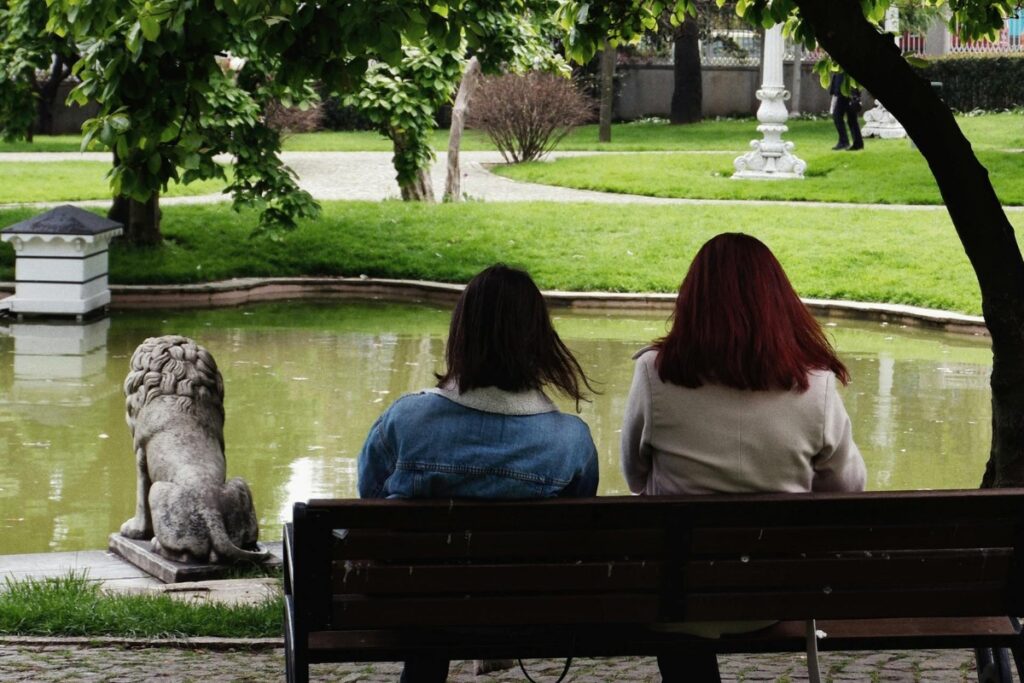 Women Sitting on Bench at Park